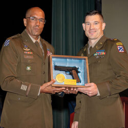 Major Marc C. Beaudoin receives the General George C. Marshall Award from Gen. Gary Brito, honoring him as the top United States graduate in the Command and General Staff Officers Class of 2024 at graduation, June 7, 2024, in the Eisenhower Auditorium of the Lewis and Clark Center on Fort Leavenworth, Kansas. (photo by Dan Neal/ArmyU Public Affairs)